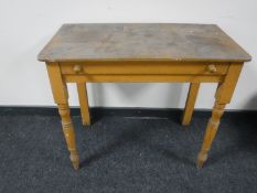 An antique pine side table fitted a drawer