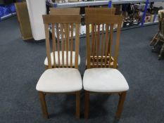 A set of four contemporary oak rail back chairs CONDITION REPORT: One chair lacking
