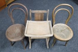 Two child's bentwood chairs together with a child's feeding chair