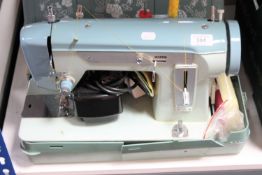A cased Jones electric sewing machine
