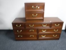 A contemporary mahogany seven drawer chest together with matching two drawer bedside chest