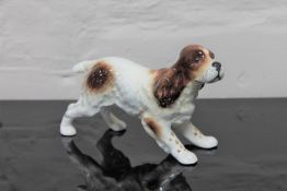 A Beswick china figurine : Spaniel Running, model 1057, gloss, height 10 cm.