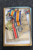 A box containing military items including two WWI medals presented to 36506 PTE. E. BURTON. LEIC. R.