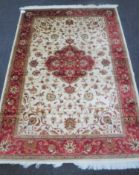 A Keshan rug on beige ground,