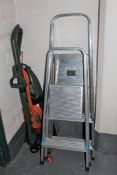 Two sets of aluminium folding steps, together with a Black & Decker electric strimmer and