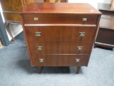 A mid 20th century teak four drawer chest CONDITION REPORT: 94cm high by 77cm wide