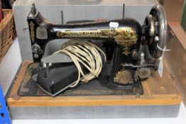 A cased mid 20th century Singer sewing machine