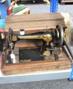 An oak cased vintage Singer hand sewing machine