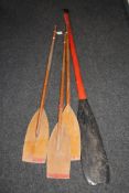 Four wooden boat oars