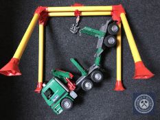 A large scale Bruder logging truck with unloading frame