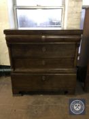 An antique continental oak four drawer chest