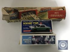 A vintage German tin plate Technofix bus terminal with original box and two other boxed toys
