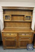 A reproduction carved oak dresser,