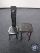 A carved ebonised occasional table together with a spinning chair