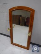 A mahogany wall mirror with brass sconces