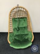 A wicker and bamboo hanging egg chair with cushion