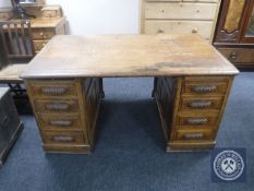An early 20th century oak twin pedestal desk