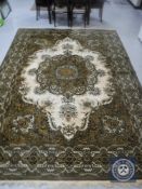 A fringed floral machine made carpet on olive ground