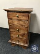 A contemporary narrow hardwood five drawer chest