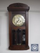 An early twentieth century oak wall clock