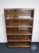 A mid 20th century five tier stacking glazed door bookcase