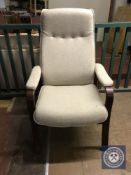 A stained wood high backed armchair