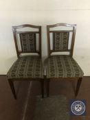 A pair of antique mahogany dining chairs