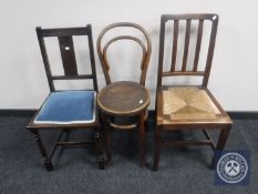An oak rush seated bedroom chair together with a bentwood high chair