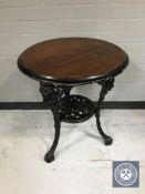 A circular Britannia pub table on cast iron base