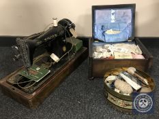 A cased vintage sewing machine,