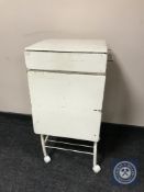 A mid twentieth century medical cabinet on wheels