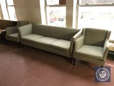A mid twentieth century three piece lounge suite upholstered in a green fabric