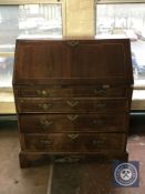 An inlaid mahogany Regency style bureau