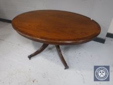 An oval inlaid mahogany pedestal coffee table