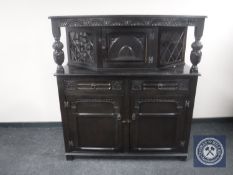 A carved oak buffet backed sideboard