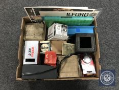 A box of assorted cameras and accessories