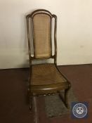 An antique mahogany bergere rocking chair