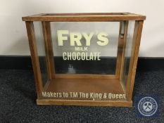 A vintage glass display cabinet with later 'Frys' advertising.