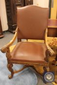 A carved oak 17th century style armchair in brown studded leather