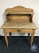 An early 20th century oak writing table with shelf fitted a drawer