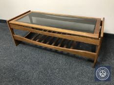 A late twentieth century teak glass topped coffee table with under shelf