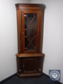 A mahogany glazed door corner display cabinet