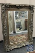 An ornate silvered bevelled mirror,