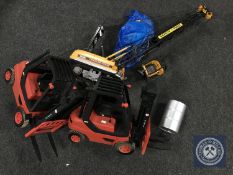 A remote control Caterpillar crane and two remote controlled fork lift trucks