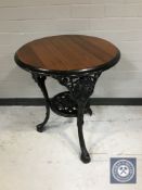 A circular Britannia pub table on cast iron base