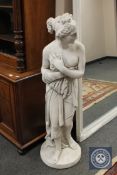 A plaster figure depicting a scantily clad maiden,