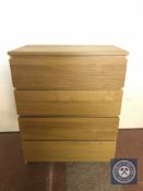 A contemporary oak four drawer chest