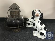 A copper ship's light with red glass shade and a pair of Staffordshire dogs