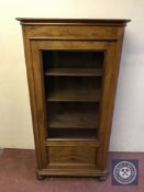 An early 20th century walnut display cabinet on bun feet (key with saleroom staff)