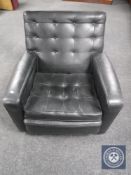 A mid 20th century black buttoned vinyl armchair